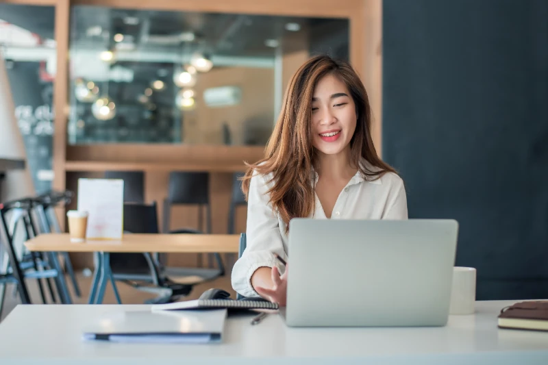 Charming asian businesswoman witting working on laptop